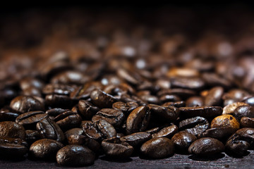 coffee background, closeup of dark brown roasted coffee beans,