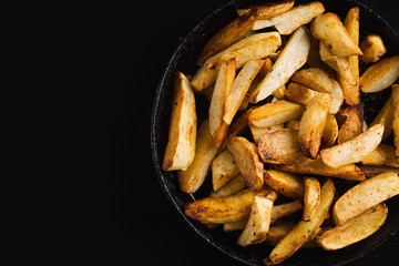 Fried potatoes on a black frying pan