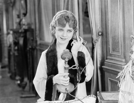 Portrait of woman using telephone 