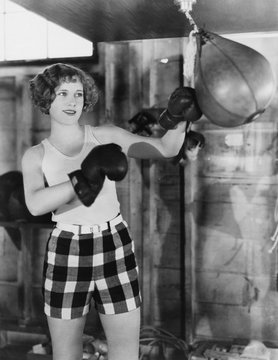 Female Boxer Using Punching Bag 