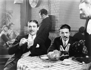 Two men sitting together at a restaurant 