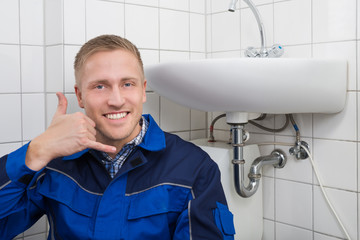 Happy Plumber Making Call Me Gesture