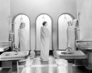 Three women in a bathroom together 
