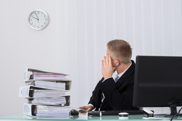 Male Businessman Looking At Clock