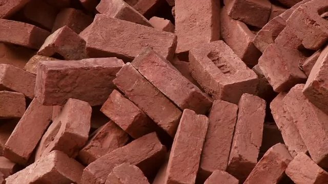 Static view of red bricks in a pile in India