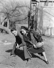 Couple playing football with each other 