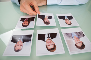 Businessman Hand Choosing Photograph Of A Candidate