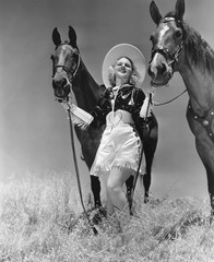 Cowgirl with two horses  - 104448296