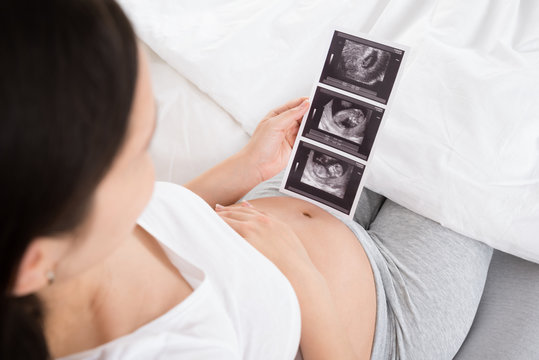 Pregnant Woman With Ultrasound Image Of Baby