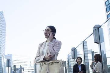 Business woman is make a phone call in the office district