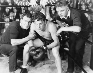 Boxer in corner with trainers 