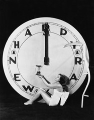 Woman with clock at midnight on New Years Eve 
