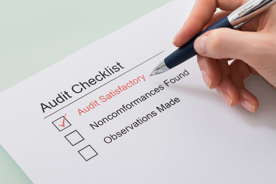 Woman Filling Audit Checklist Form