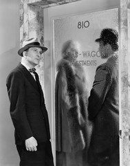 Man eavesdropping outside investment office 
