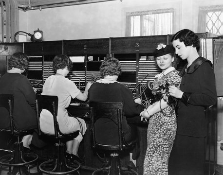 Telephone operators at switchboard 