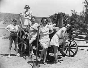 Portrait of women with agricultural tools 