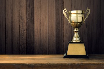 Trophies placed on a wooden floor with a space. - obrazy, fototapety, plakaty