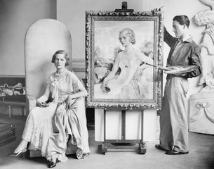 Artist painting portrait of posing woman 