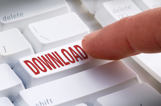 Closeup of a big DOWNLOAD button on a keyboard with a finger getting ready to hit it and make an online download and purchase