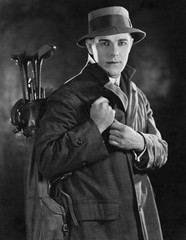 Portrait of man carrying golf clubs 