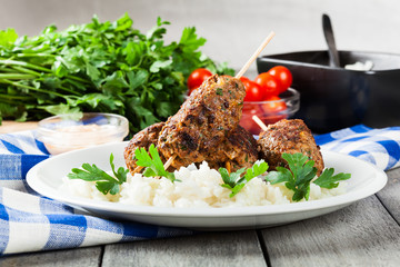 Barbecued kofta with rice on a plate