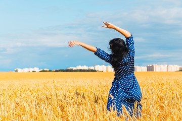 Beautiful brunette woman in wheat field