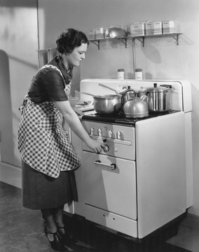 Woman Cooking On Stove 