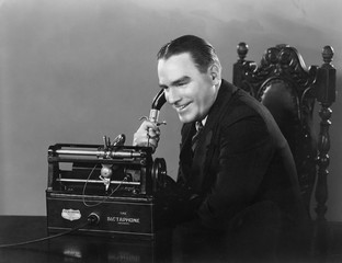 Smiling man using Dictaphone 