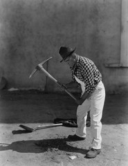 Man working with pick axe 