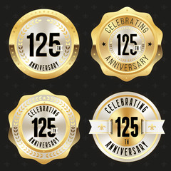 Collection of gold  125th anniversary badges on black background
