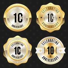 Collection of gold  10th anniversary badges on black background
