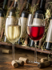 Wine bottles on the wooden shelf.
