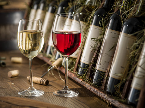 Wine bottles on the wooden shelf.