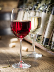 Wine bottles on the wooden shelf.