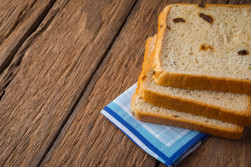 Sweet bread with cinnamon and raisins for dessert on the wood table