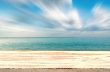 Fototapeta na wymiar Wood floor on beach and blue sky background