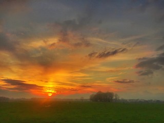 Fototapeta na wymiar dramatic meadow sunset