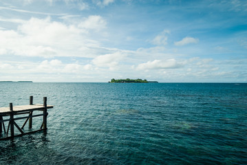 Fototapeta na wymiar Pulau Tengah, in the distance, as seen from Pulau Cendekian, Karimunjawa, Indonesia.