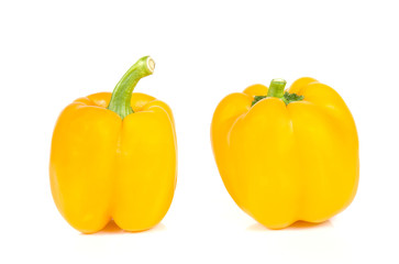 Yellow bell peppers cut pieces on white background.