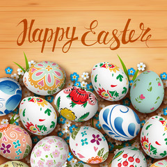 Easter eggs and flowers on the wooden table