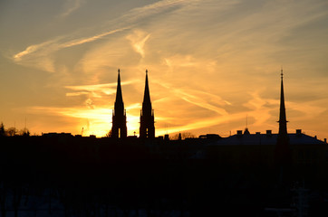 Helsinki silhouette at sunset. Towers of the St. John's Church and the German Church.