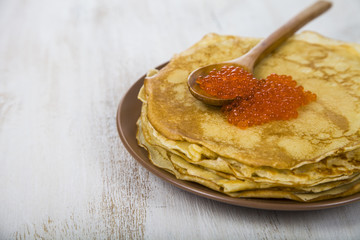 Pancakes with red caviar on a table