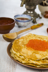 Pancakes with red caviar on a table