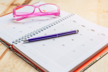 Notebook and pen with glasses calendar format