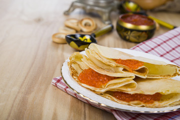 Pancakes with caviar on the table