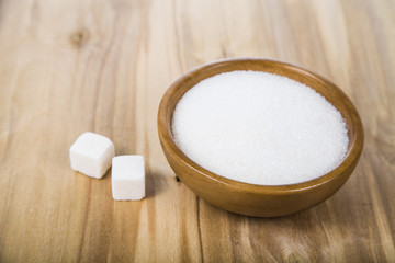 Fototapeta na wymiar Sugar in a wooden bowl