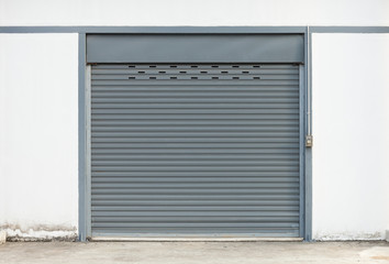 Fototapeta na wymiar Storefront or shopfront is a facade or entryway of retail store. Protection with security door also called roller door or roller shutter. Motorised type by automatic operation with electrical power.