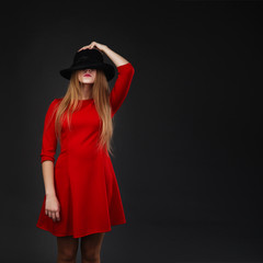 Girl holding hat up to face