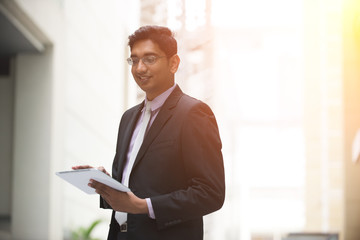 indian male using tablet outdoor