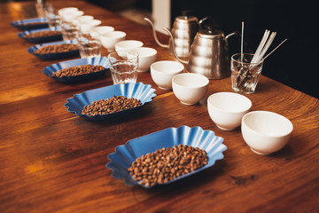 Rows of cups, glasses and containers with coffee beans